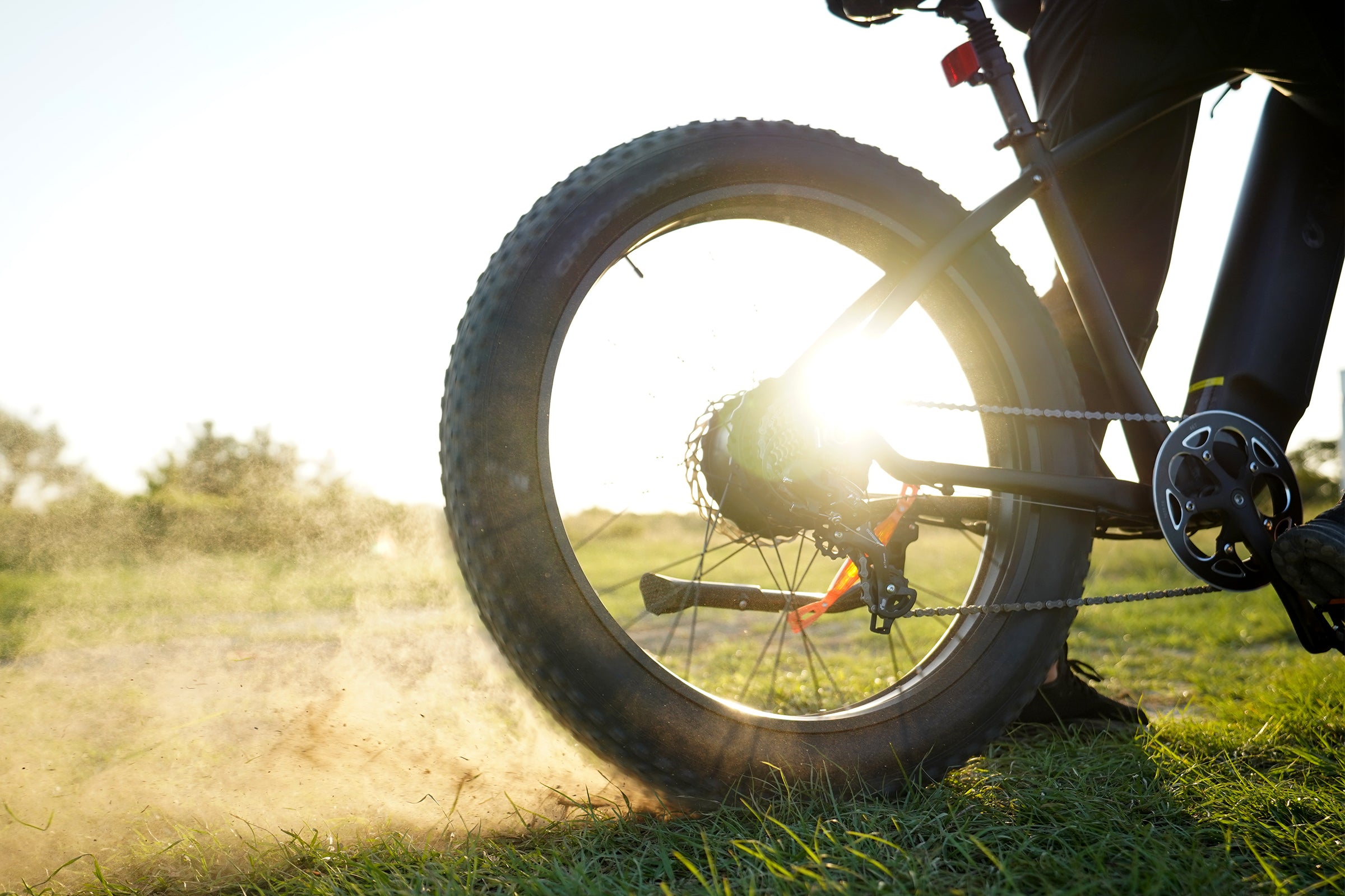 Ruota della bicicletta elettrica DYU King 750 sollevando polvere su un sentiero. Ruota della bicicletta elettrica DYU King 750 sollevando polvere su un sentiero.